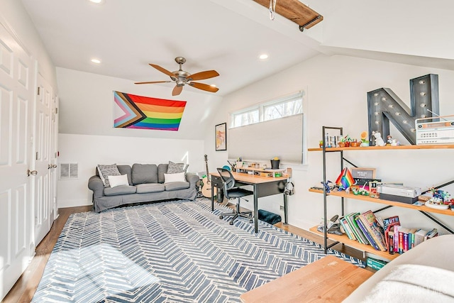 living area featuring visible vents, vaulted ceiling, a ceiling fan, and wood finished floors