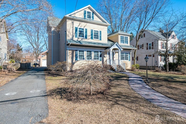traditional-style home with fence and a garage