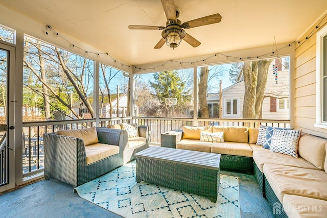 sunroom / solarium featuring a ceiling fan and a wealth of natural light