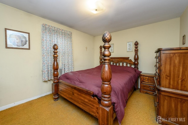 bedroom with light carpet and baseboards