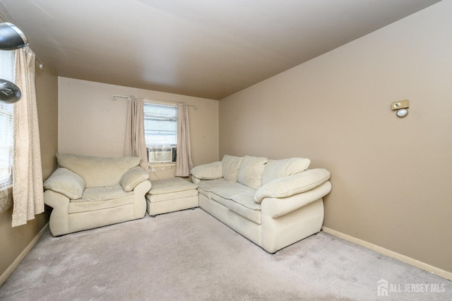 carpeted living room with baseboards