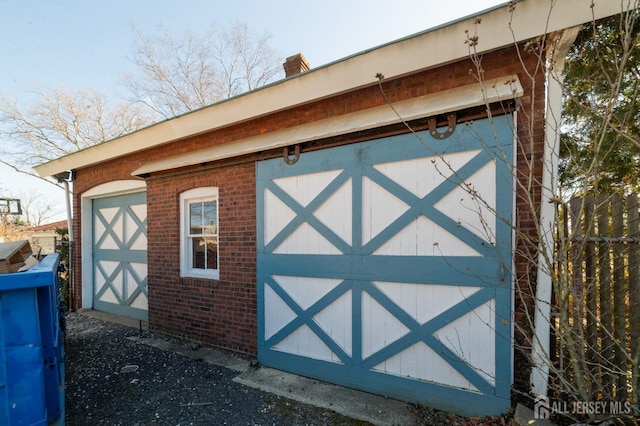 view of outdoor structure featuring an outbuilding and fence