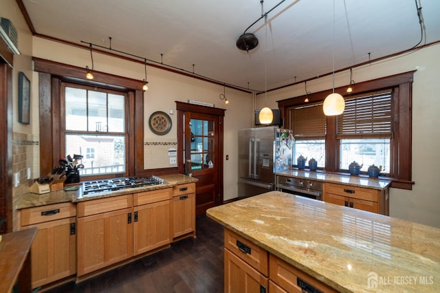 kitchen with tasteful backsplash, light stone counters, stainless steel appliances, and dark wood finished floors