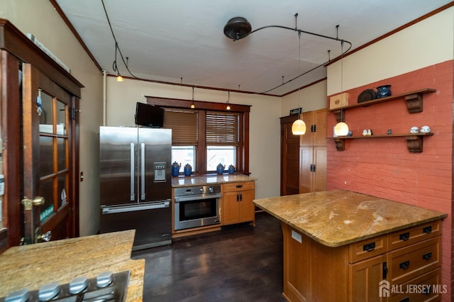 kitchen featuring light stone countertops, crown molding, stainless steel appliances, and dark wood finished floors