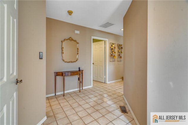 entryway with light tile patterned floors, visible vents, and baseboards