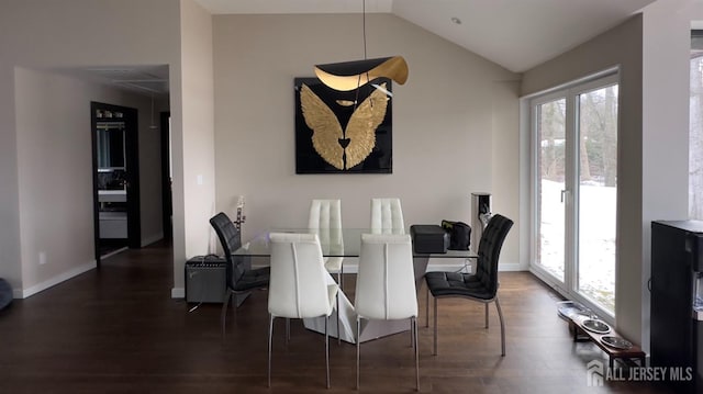 dining room with lofted ceiling and dark hardwood / wood-style floors