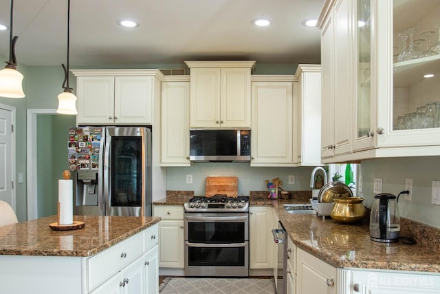 23 Keswick Cir, Monroe, NJ 08831 - kitchen with stainless steel appliances, a sink, dark stone counters, glass insert cabinets, and recessed lighting