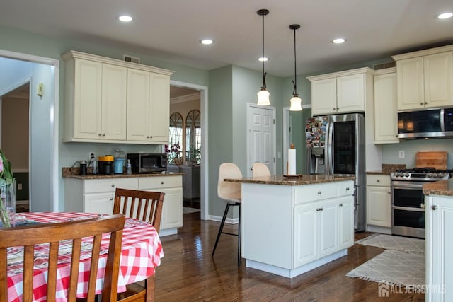 23 Keswick Cir, Monroe, NJ 08831 - kitchen with appliances with stainless steel finishes, a center island, hanging light fixtures, dark wood-style flooring, and white cabinetry