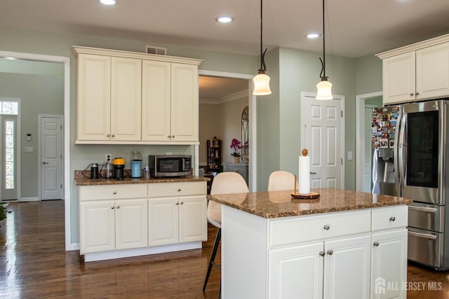 23 Keswick Cir, Monroe, NJ 08831 - kitchen featuring appliances with stainless steel finishes, dark stone countertops, dark wood-style floors, decorative light fixtures, and a kitchen island