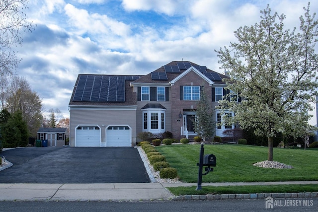 23 Keswick Cir, Monroe, NJ 08831 - view of front facade with asphalt driveway, a garage, solar panels, and a front yard