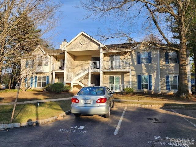 view of property featuring uncovered parking