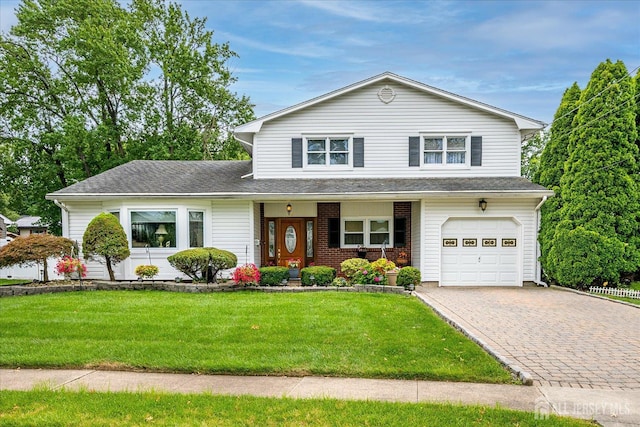 10 Rainbow Dr, Colonia, NJ 07067 - view of front of home featuring a front lawn, decorative driveway, a garage, and a shingled roof