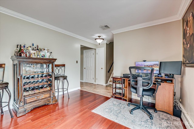 10 Rainbow Dr, Colonia, NJ 07067 - home office featuring crown molding, wood finished floors, a baseboard heating unit, and a bar