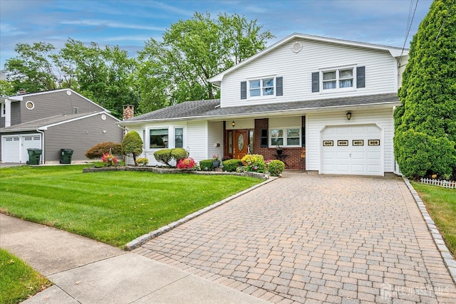 10 Rainbow Dr, Colonia, NJ 07067 - traditional-style house with decorative driveway, an attached garage, a front yard, and brick siding