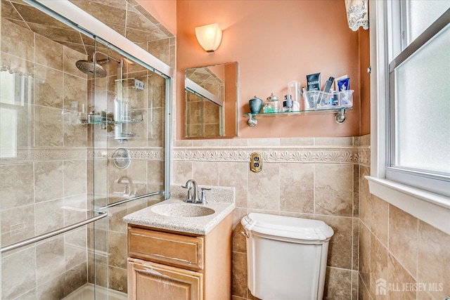 10 Rainbow Dr, Colonia, NJ 07067 - bathroom with a shower stall, vanity, tile walls, and a wainscoted wall