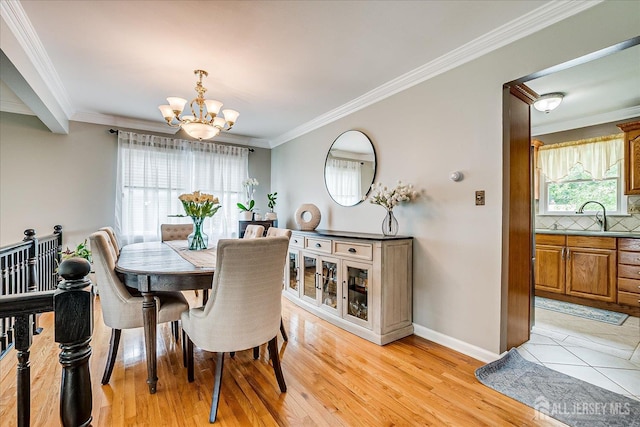 10 Rainbow Dr, Colonia, NJ 07067 - dining room featuring a chandelier, crown molding, and light wood-type flooring