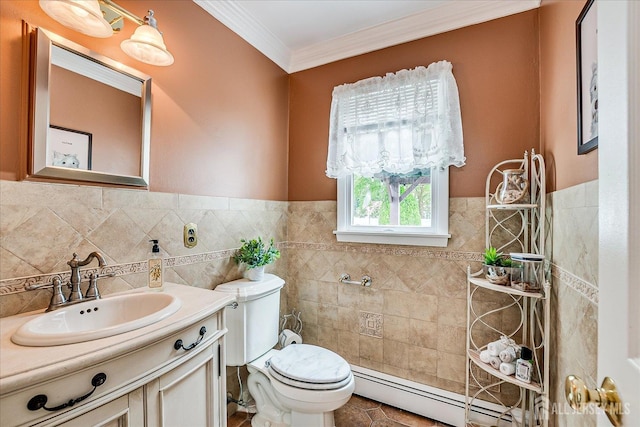 10 Rainbow Dr, Colonia, NJ 07067 - bathroom featuring tile walls, a baseboard heating unit, ornamental molding, vanity, and a wainscoted wall