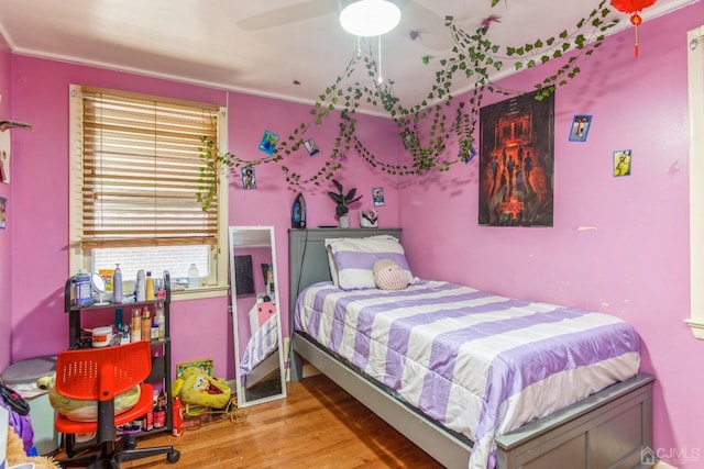 bedroom featuring hardwood / wood-style flooring and ceiling fan