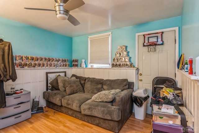 living room with light hardwood / wood-style flooring and ceiling fan