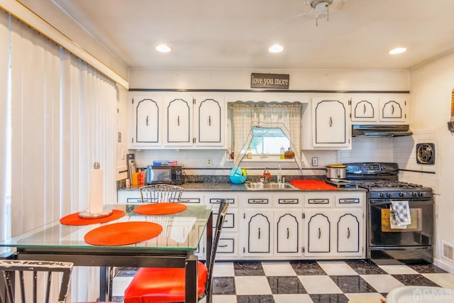 kitchen with backsplash, white cabinets, sink, and black appliances