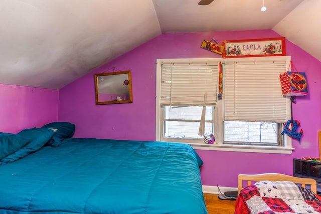 bedroom featuring vaulted ceiling, hardwood / wood-style floors, and ceiling fan