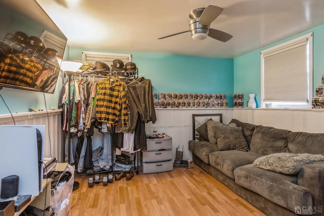 walk in closet with ceiling fan and light wood-type flooring