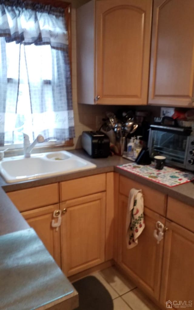 kitchen with sink and light tile patterned floors