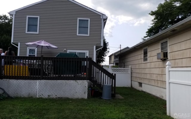 back of house featuring a yard, cooling unit, and a deck