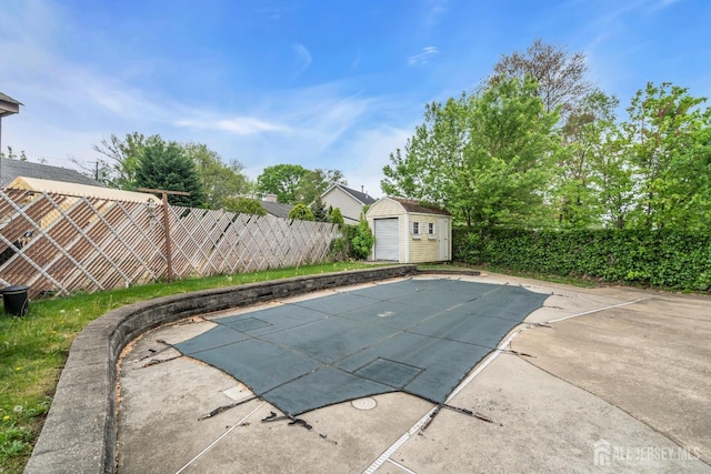view of pool with a fenced backyard, a shed, an outdoor structure, and a patio