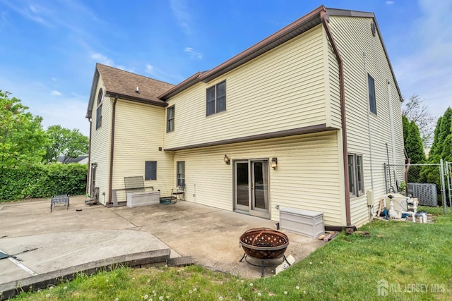 back of house featuring an outdoor fire pit and a patio