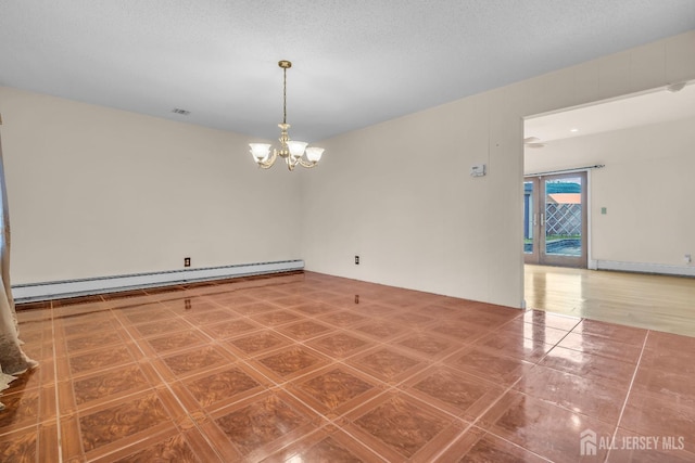 unfurnished room with a baseboard heating unit and a chandelier