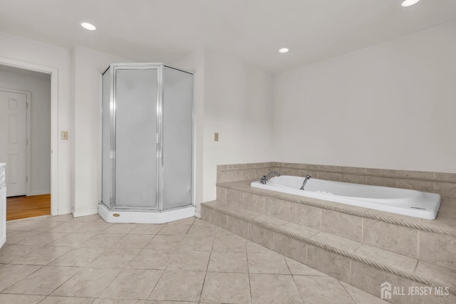 bathroom with tile patterned floors, a stall shower, a bath, and recessed lighting
