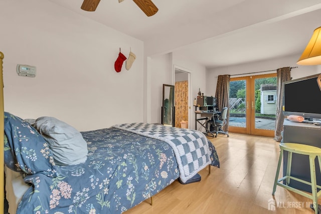 bedroom featuring french doors, access to outside, wood finished floors, ceiling fan, and a desk