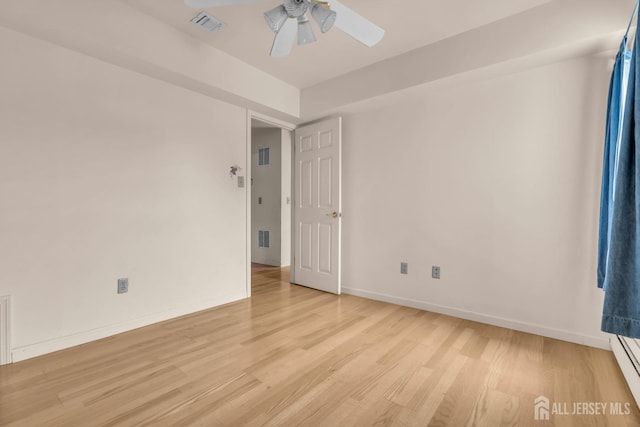 unfurnished room featuring light wood finished floors, a ceiling fan, and baseboards