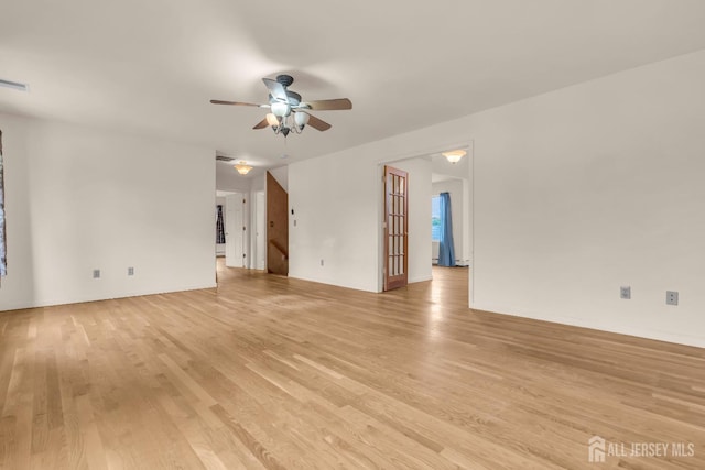 unfurnished living room with light wood-type flooring and ceiling fan
