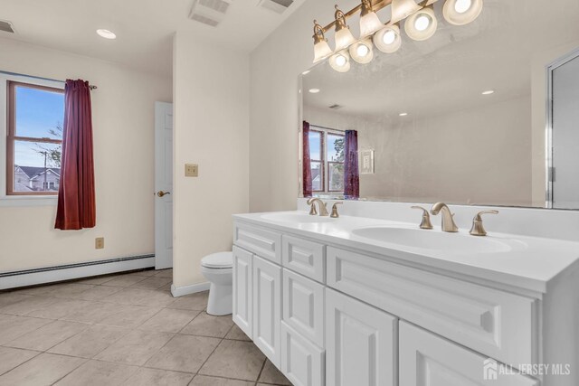 full bathroom featuring a baseboard heating unit, tile patterned flooring, toilet, double vanity, and recessed lighting
