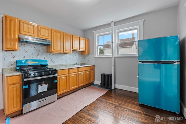 89 Woodbridge Ave, Highland Park, NJ 08904 - kitchen featuring freestanding refrigerator, radiator heating unit, stainless steel gas range oven, under cabinet range hood, and a sink