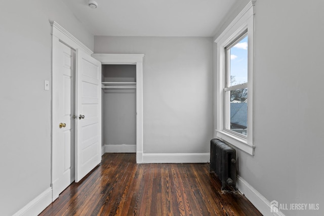 89 Woodbridge Ave, Highland Park, NJ 08904 - unfurnished bedroom with baseboards, radiator, dark wood finished floors, and a closet