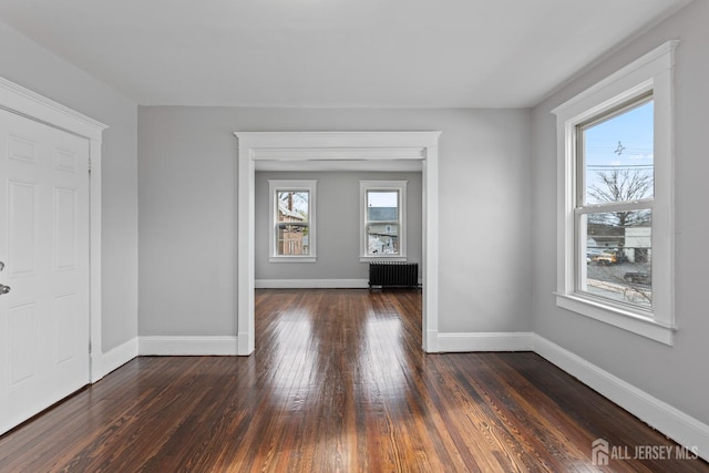 89 Woodbridge Ave, Highland Park, NJ 08904 - unfurnished room with baseboards, radiator, and dark wood-style flooring