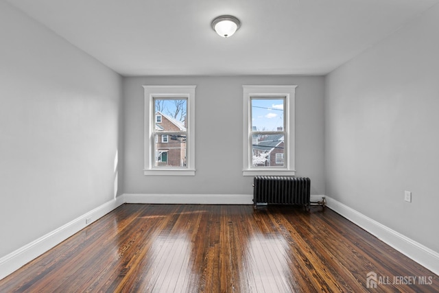 89 Woodbridge Ave, Highland Park, NJ 08904 - empty room with radiator heating unit, baseboards, and dark wood-style flooring