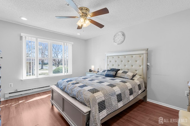 375-C Duranta Plz, Monroe, NJ 08831 - bedroom featuring a baseboard radiator, wood finished floors, a textured ceiling, ceiling fan, and baseboards