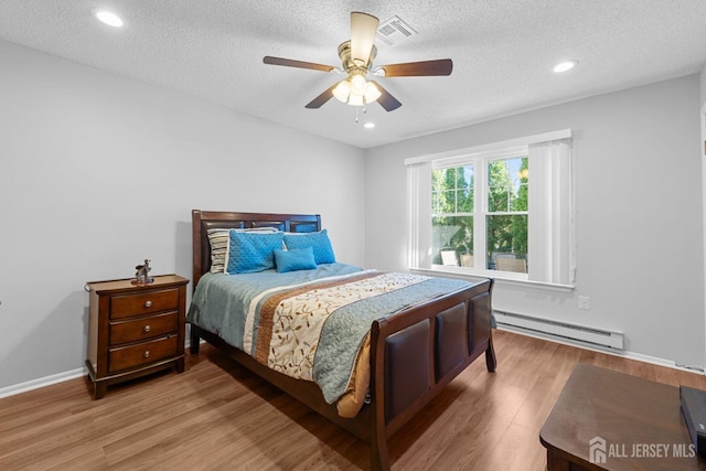 375-C Duranta Plz, Monroe, NJ 08831 - bedroom featuring baseboard heating, a textured ceiling, wood finished floors, ceiling fan, and recessed lighting