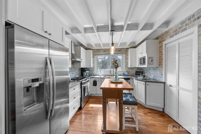 11 Stockton Rd, New Brunswick, NJ 08901 - kitchen featuring appliances with stainless steel finishes, light wood-type flooring, tasteful backsplash, white cabinets, and beam ceiling