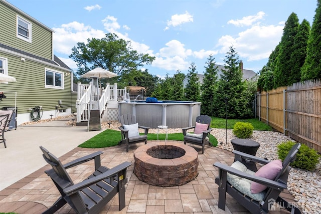 11 Stockton Rd, New Brunswick, NJ 08901 - fenced backyard with a fire pit, a deck, a patio area, and stairs
