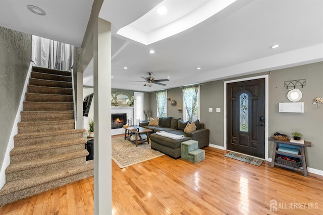 11 Stockton Rd, New Brunswick, NJ 08901 - living room featuring stairs, wood-type flooring, recessed lighting, a fireplace, and a ceiling fan