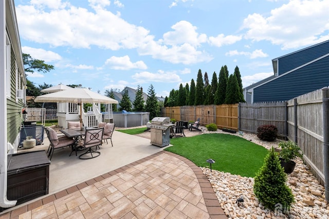 11 Stockton Rd, New Brunswick, NJ 08901 - fenced backyard with a patio area, outdoor dining area, and grilling area