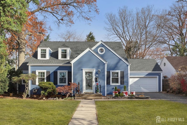 cape cod home with a front yard and a garage