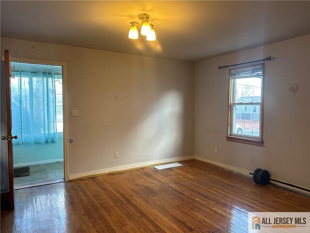 spare room with hardwood / wood-style floors