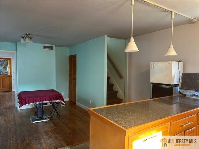 kitchen with white fridge, dark wood-type flooring, and billiards