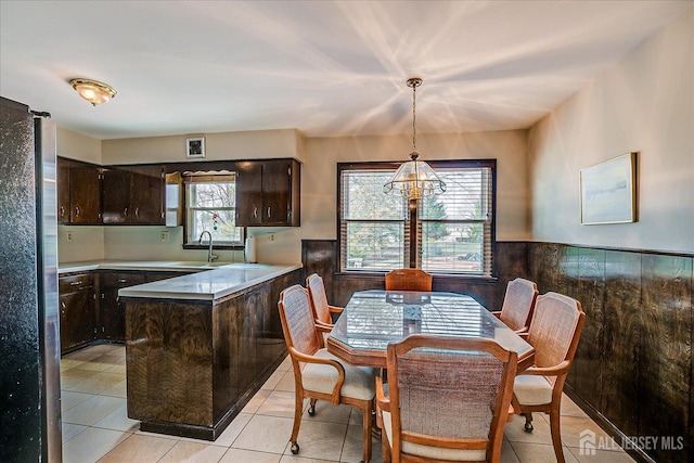 31 Riverview Ter, Hillsborough, NJ 08844 - kitchen with freestanding refrigerator, dark brown cabinetry, wainscoting, a peninsula, and light countertops